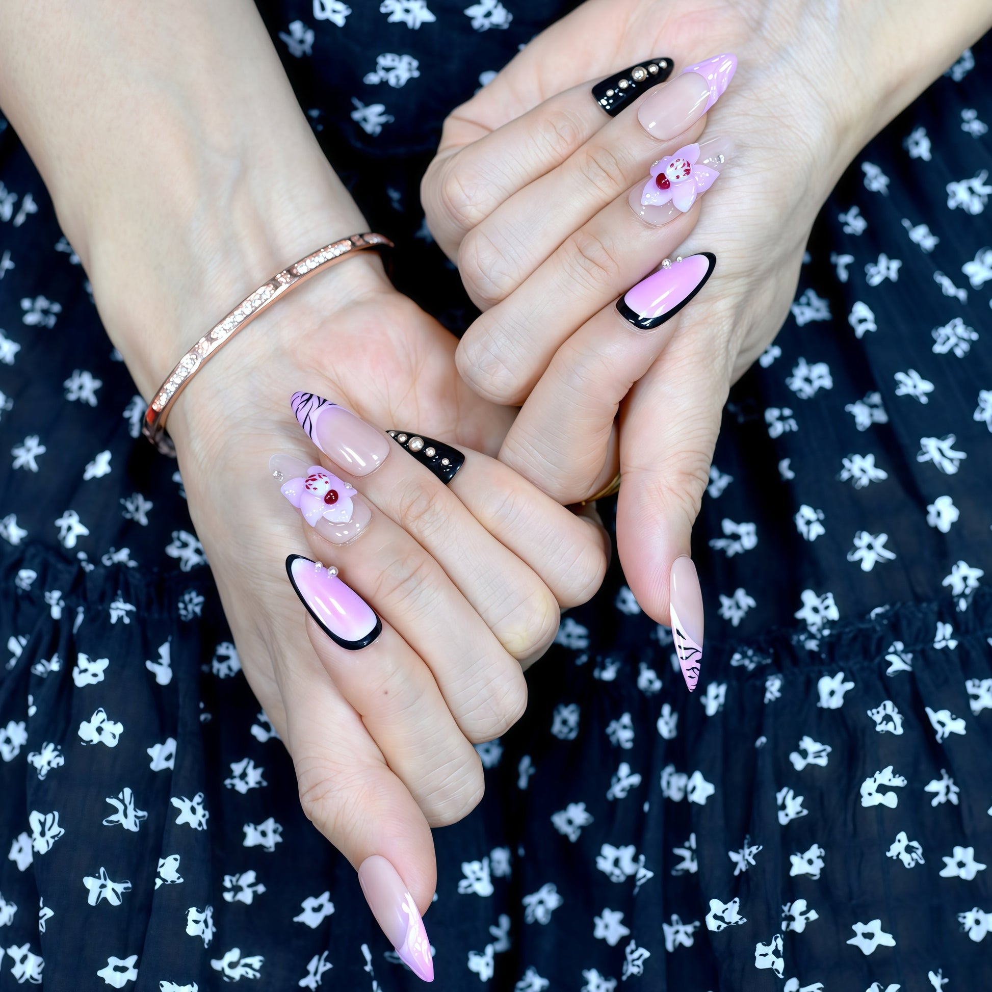 Medium Almond press-on nails in pink ombré with black zebra print, 3D orchid flowers, and rhinestone-studded accents.