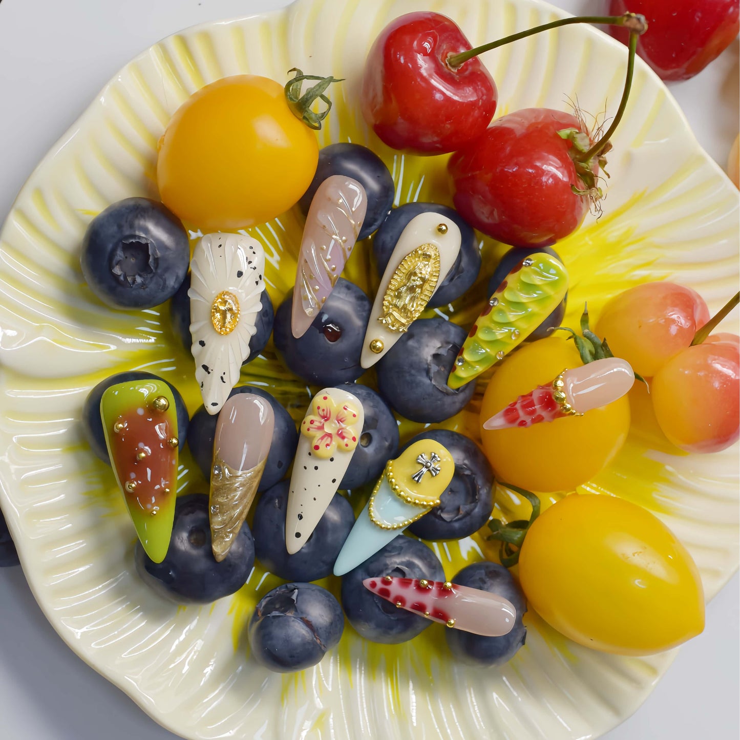 Colorful handmade fruit inspired press on nails featuring citrus slices, blueberry details and dessert inspired artwork.