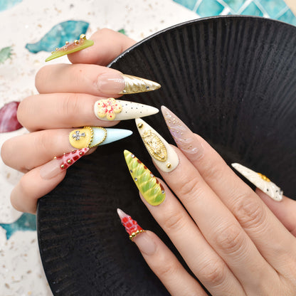 Colorful handmade fruit inspired press on nails featuring citrus slices, blueberry details and dessert inspired artwork.