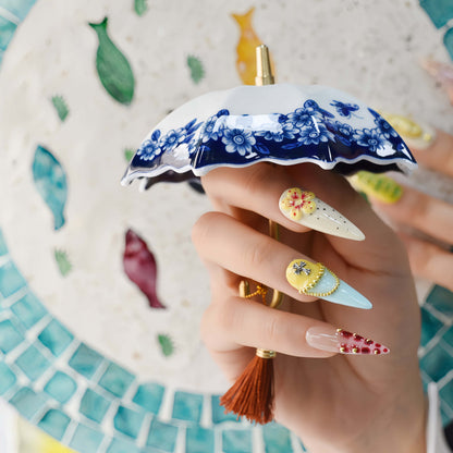 Colorful handmade fruit inspired press on nails featuring citrus slices, blueberry details and dessert inspired artwork.