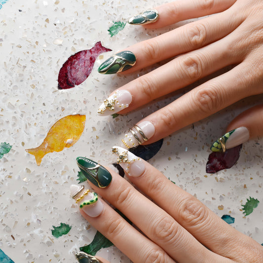 Luxury green press on nails featuring jade inspired patterns and gold metallic detailing.
