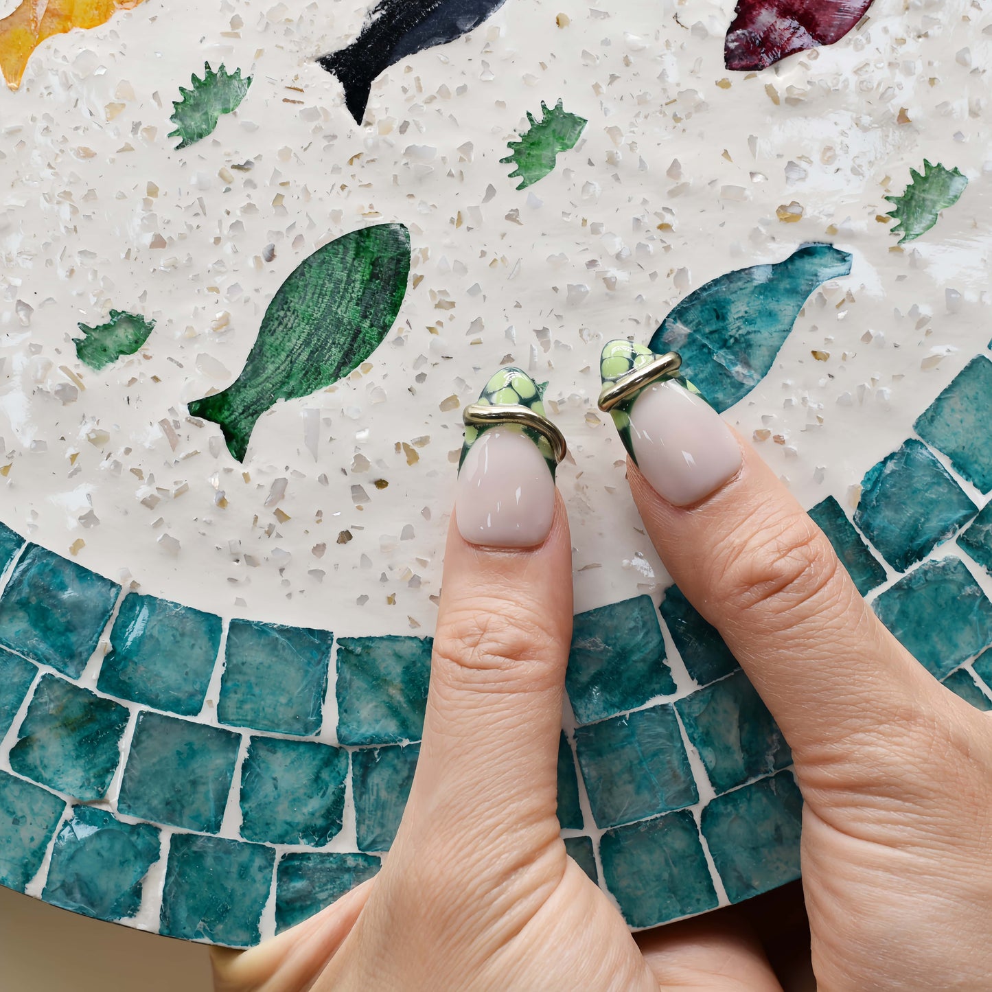 Luxury green press on nails featuring jade inspired patterns and gold metallic detailing.
