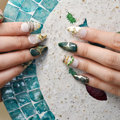 Luxury green press on nails featuring jade inspired patterns and gold metallic detailing.