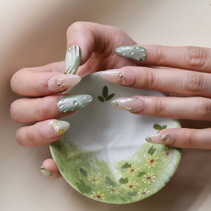 Elegant sage green and nude press on nails with gold metallic detailing and pearl accents.