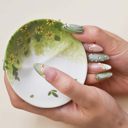 Elegant sage green and nude press on nails with gold metallic detailing and pearl accents.