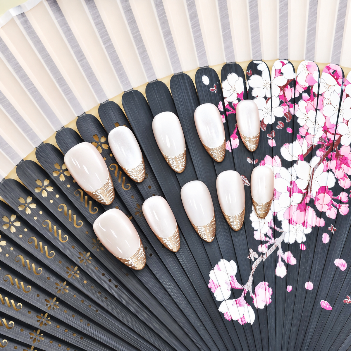 Silver Silk French sheer nude press-on nails with finely layered metallic silver tips — styled product photograph.