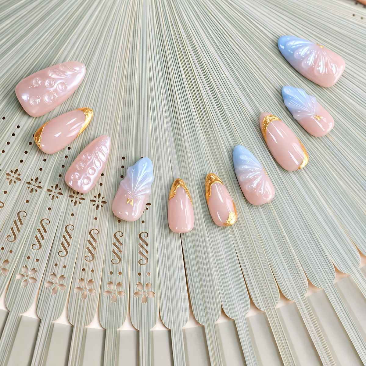 Gilded Azure Fan peach and blue press-on nails with sculpted pearl textures and gold accents — styled product photograph.
