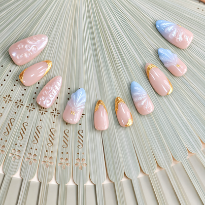 Gilded Azure Fan peach and blue press-on nails with sculpted pearl textures and gold accents — styled product photograph.