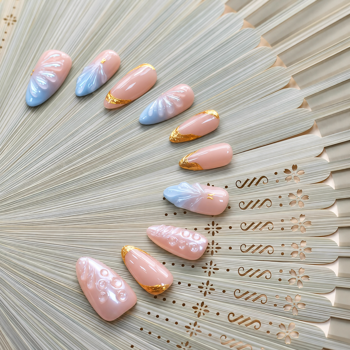 Gilded Azure Fan peach and blue press-on nails with sculpted pearl textures and gold accents — styled product photograph.