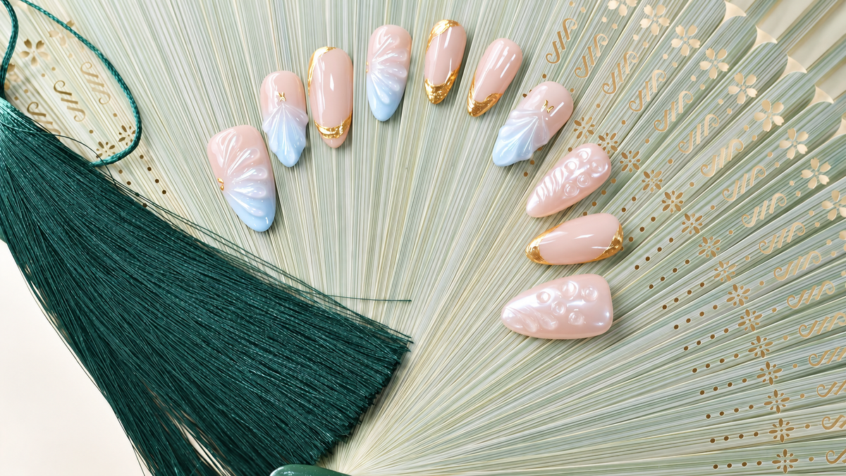 Gilded Azure Fan peach and blue press-on nails with sculpted pearl textures and gold accents — styled product photograph.