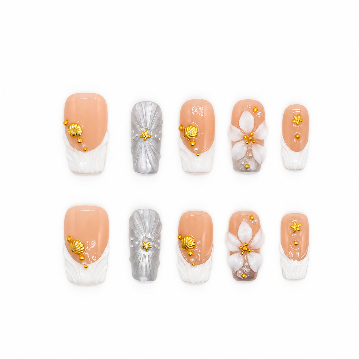Golden Shell Garden nude press-on nails with gold shells, starfish, pearls and white flowers — product set on a snow-white background.