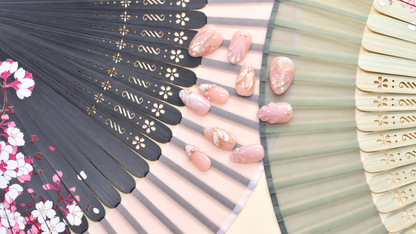 Rose Gold Leaf Veil peach press-on nails with translucent leaves, pearls and fine gold outlines — styled product photograph.