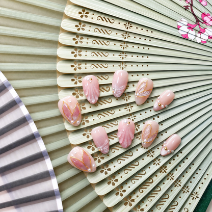 Rose Gold Leaf Veil peach press-on nails with translucent leaves, pearls and fine gold outlines — styled product photograph.