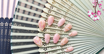 Rose Gold Leaf Veil peach press-on nails with translucent leaves, pearls and fine gold outlines — styled product photograph.