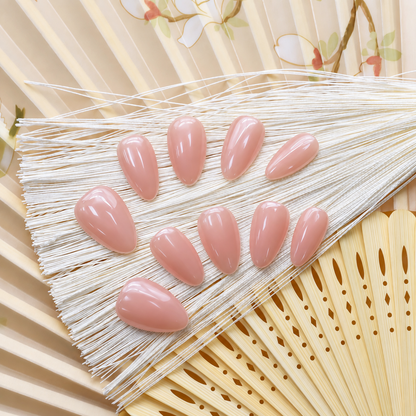 Bare Blush Veil reusable press-on nails in a sheer peach-pink nude with a glossy finish — styled product photograph.