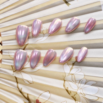 Pink Moon Chrome reusable press-on nails with a luminous blush-pink mirror finish — styled product photograph.