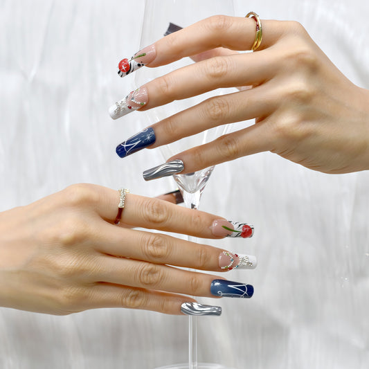 Black and white press on nails with red cherry art, gemstone chains, metallic silver accents, and modern abstract lines – Heart & Heat Collection.